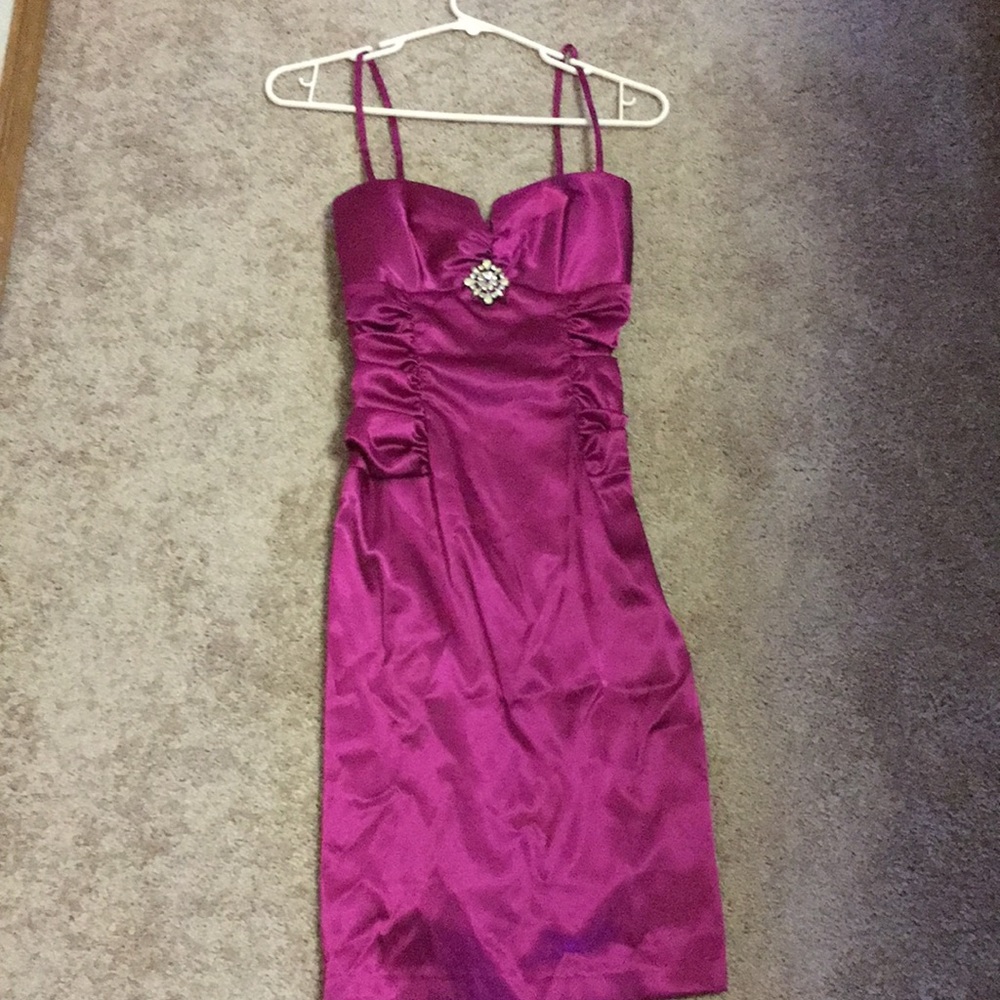 Hot pink cocktail dress with faux diamond brooch.